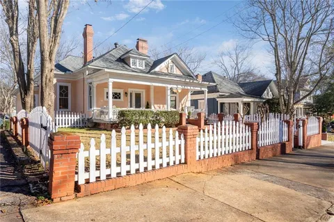 a front view of a house with a wooden fence