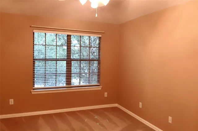 an empty room with windows and closet
