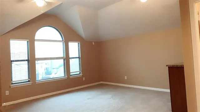 an empty room with closet and mirror