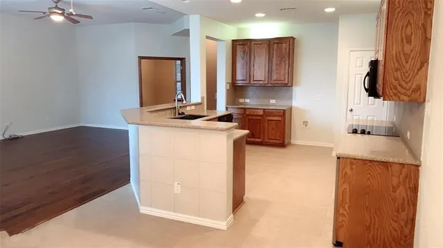 a kitchen with a sink a stove and a refrigerator