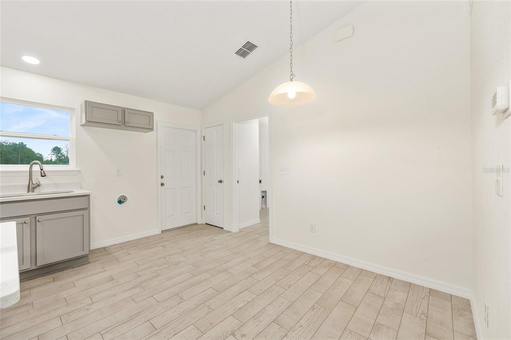 229 Locust Lane Ocala, FL 34472 - Photo 11 of 28 a view of an empty room with window and cabinet