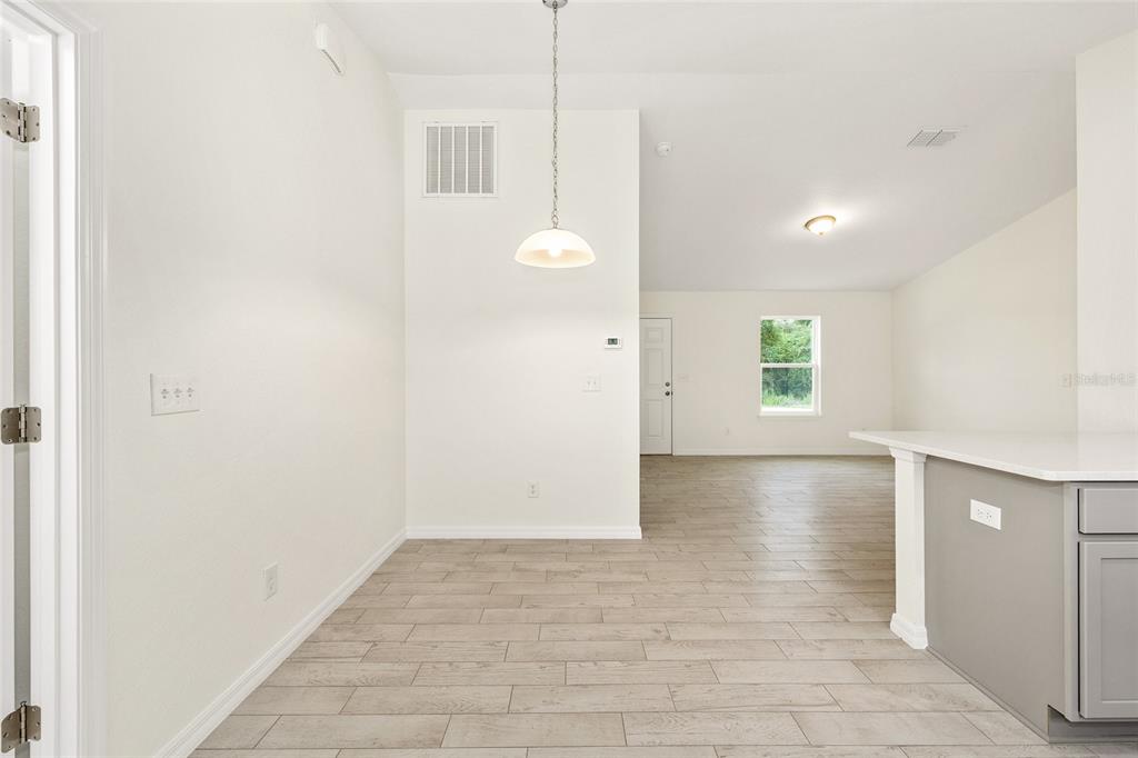 229 Locust Lane Ocala, FL 34472 - Photo 12 of 28 an empty room with windows and entrance