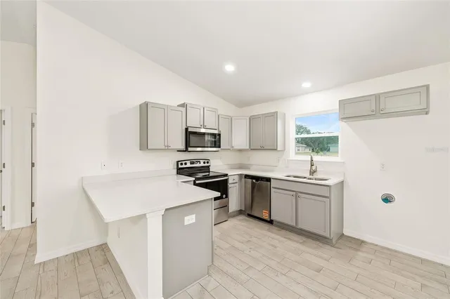 a kitchen with white cabinets and white appliances