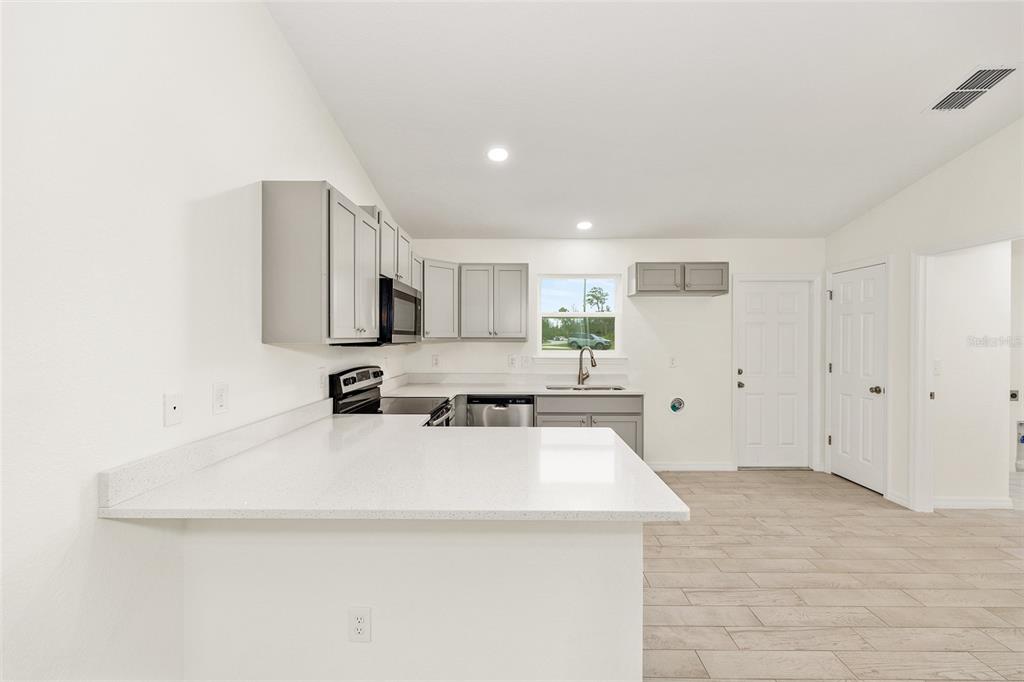 229 Locust Lane Ocala, FL 34472 - Photo 16 of 28 a kitchen with a sink a stove and cabinets
