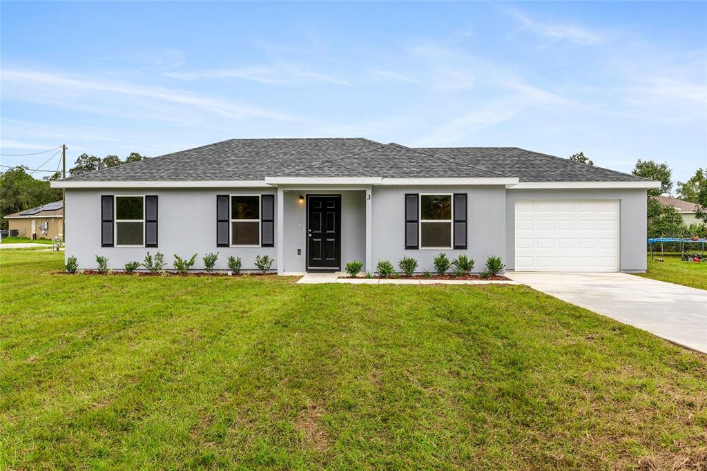229 Locust Lane Ocala, FL 34472 - Photo 2 of 28 a front view of house with yard and green space