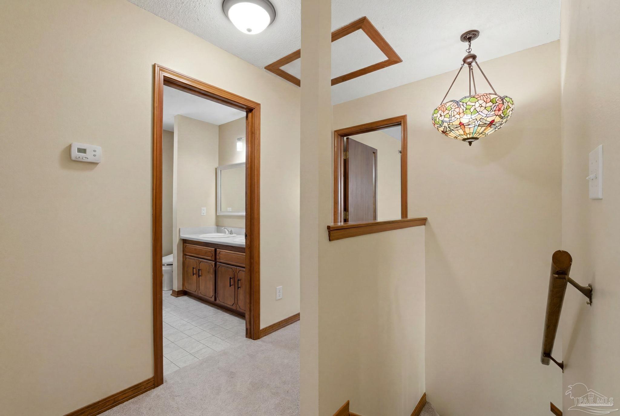 6870 Martin Road Milton, FL 32570 - Photo 21 of 48 a view of a hallway with chandelier