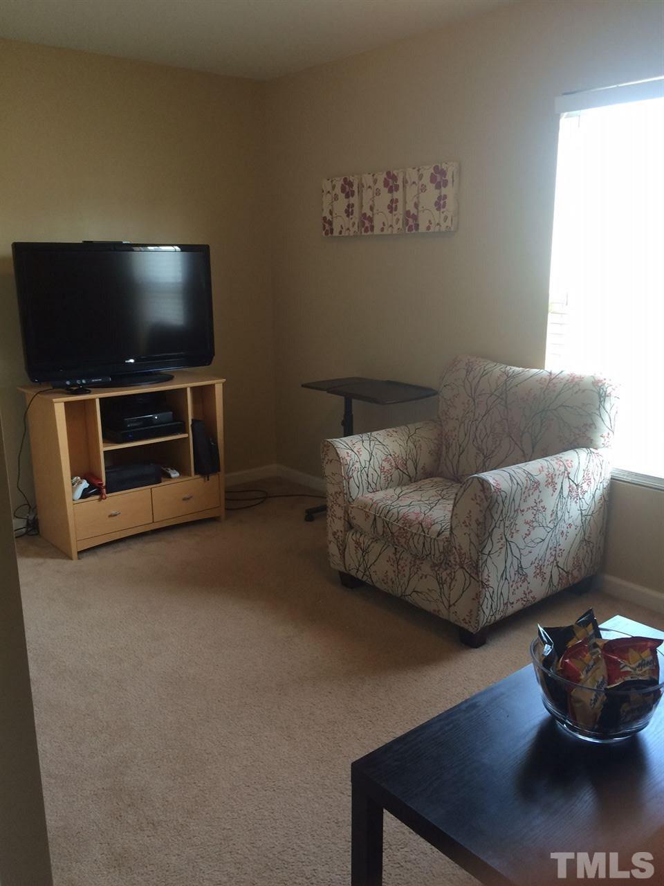 3822 Potecasi Drive Raleigh, NC 27610 - Photo 3 of 12 a living room with furniture and a flat screen tv