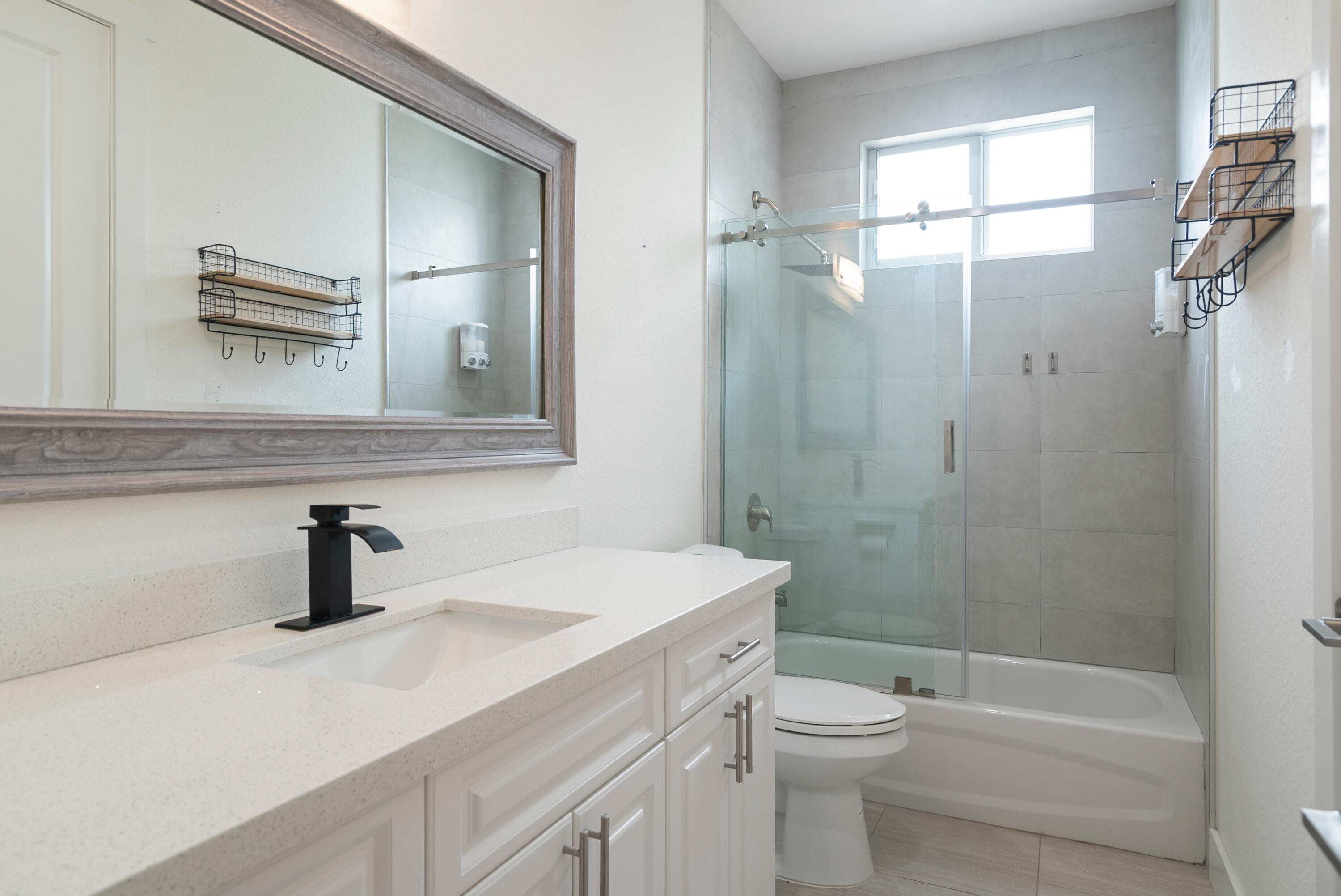 582 Boyd Drive Key Largo, FL 33037 - Photo 11 of 36 a bathroom with a sink a toilet a mirror and shower
