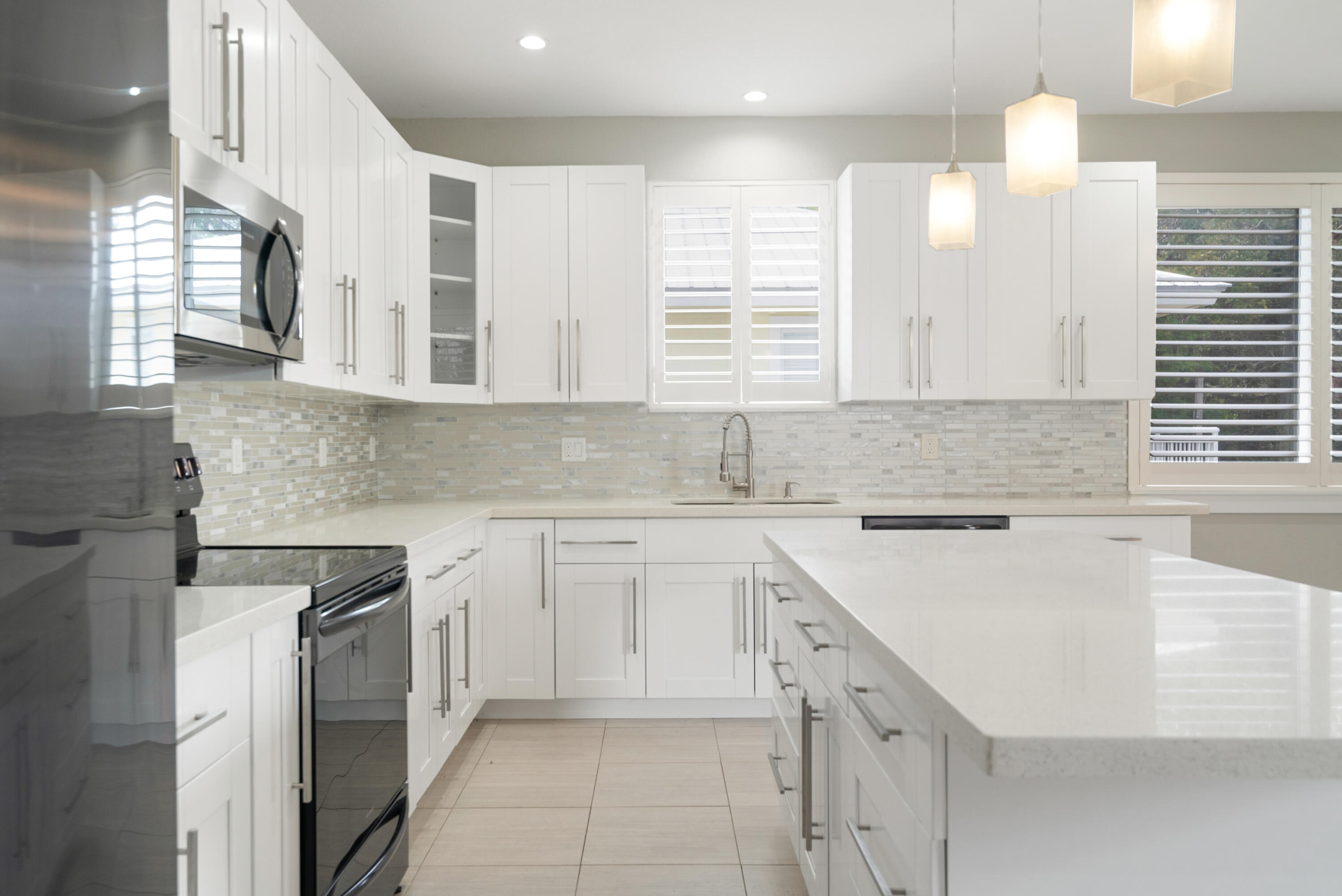 582 Boyd Drive Key Largo, FL 33037 - Photo 4 of 36 a kitchen with cabinets appliances a sink and a window