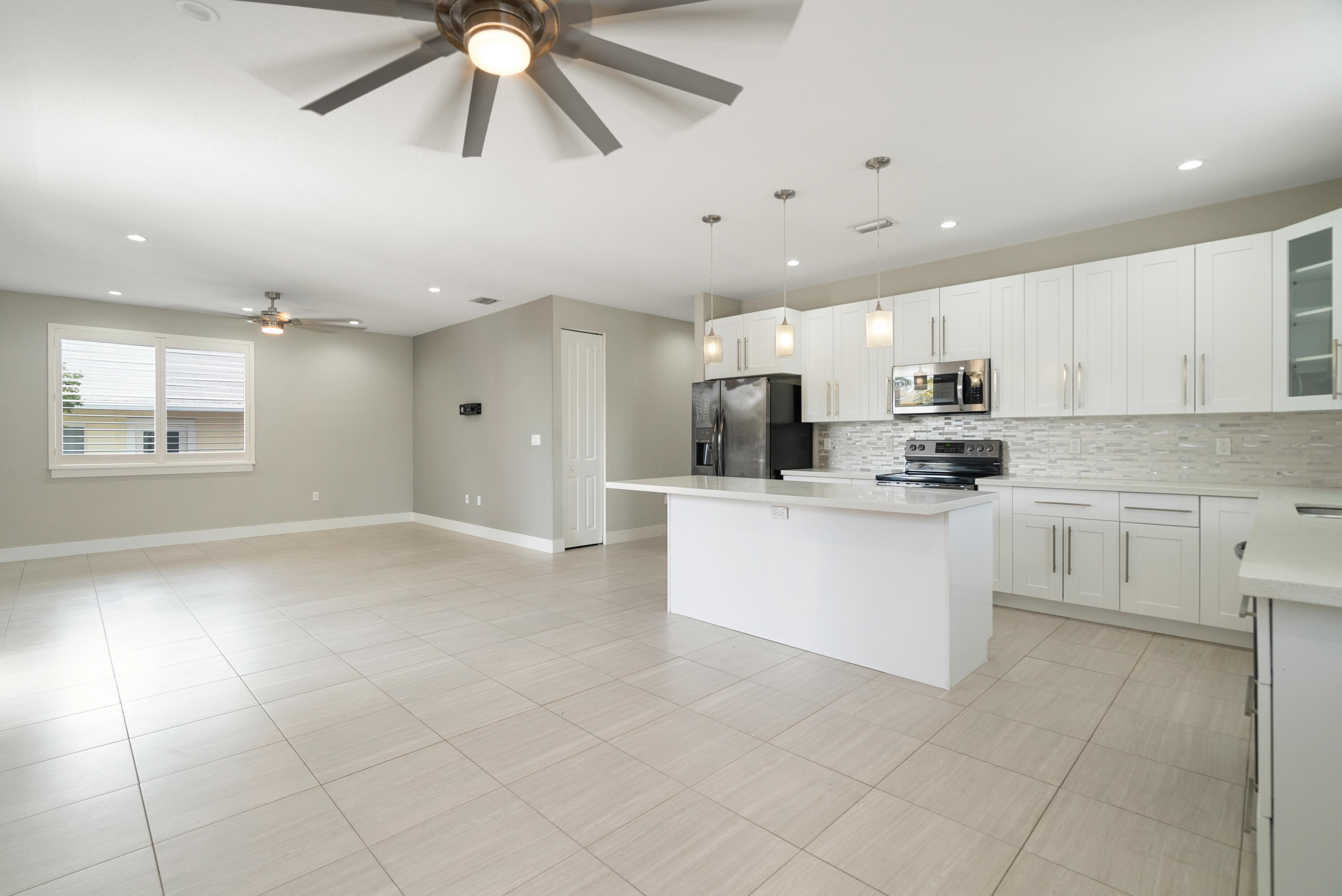 582 Boyd Drive Key Largo, FL 33037 - Photo 7 of 36 a large white kitchen with cabinets