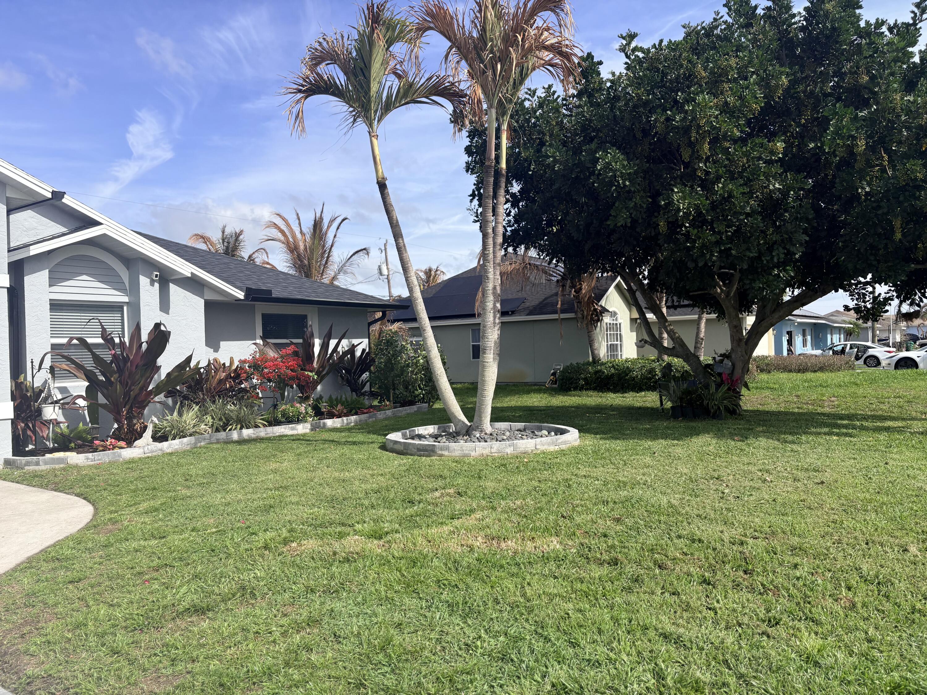 462 Southeast Cork Road Port St. Lucie, FL 34984 - Photo 11 of 57 a front view of a house with garden