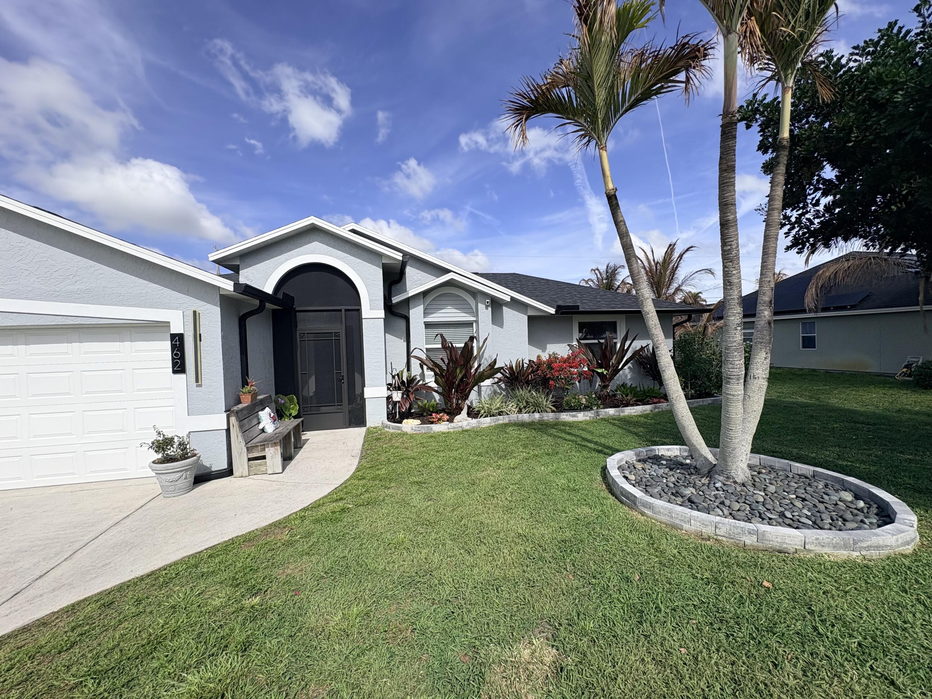 462 Southeast Cork Road Port St. Lucie, FL 34984 - Photo 12 of 57 a front view of a house with garden