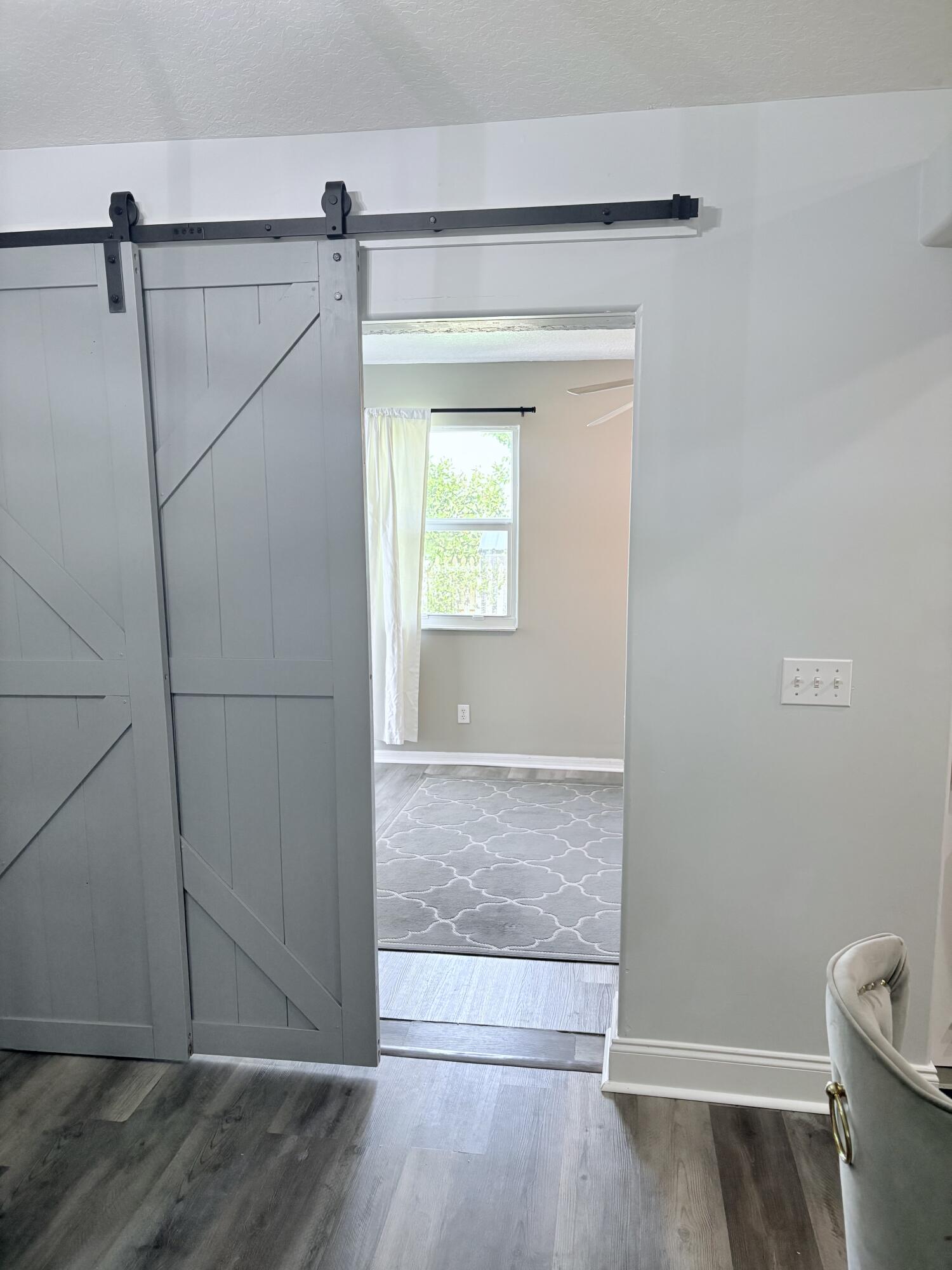 462 Southeast Cork Road Port St. Lucie, FL 34984 - Photo 22 of 57 a view of a room with wooden floor