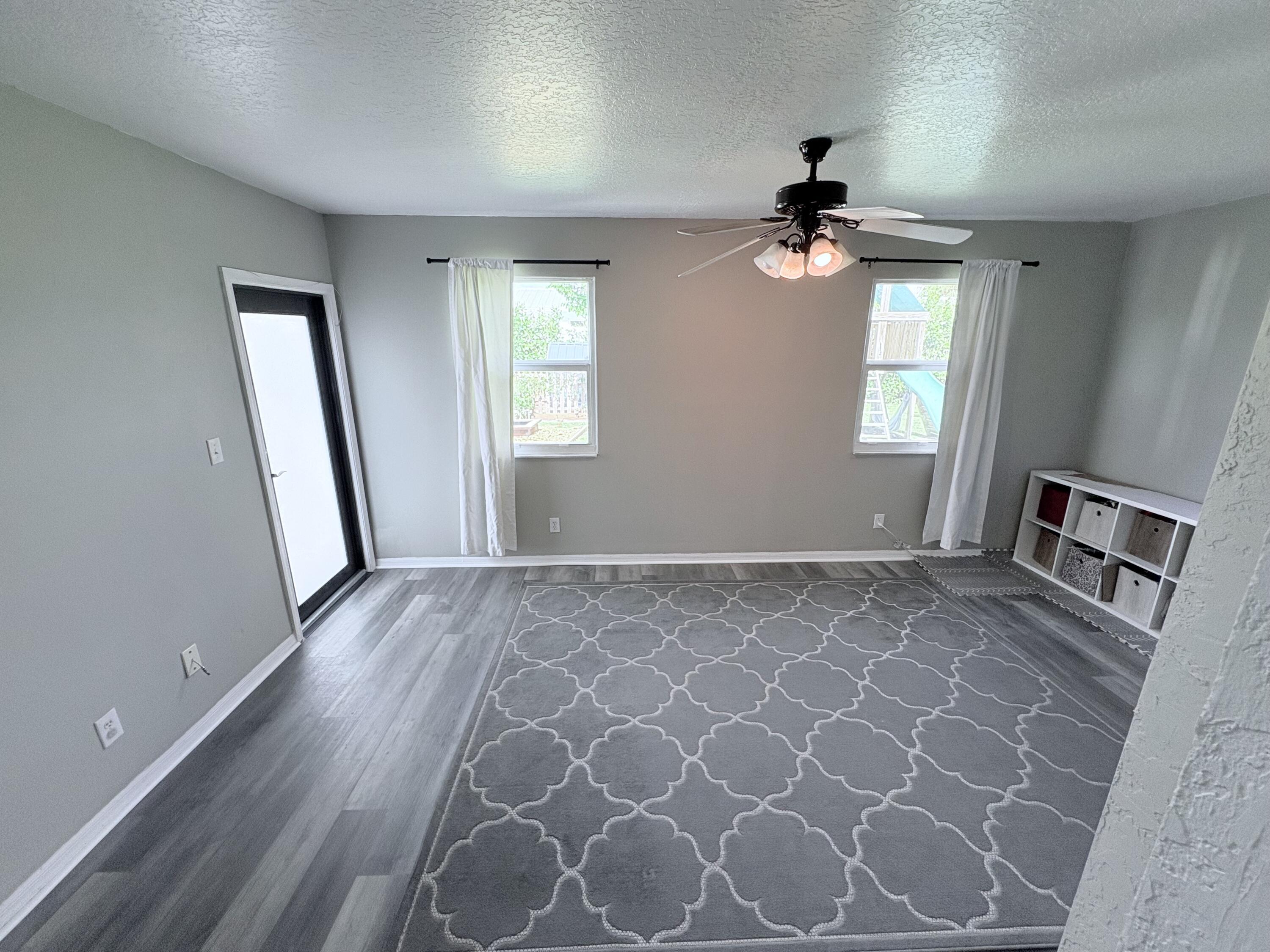 462 Southeast Cork Road Port St. Lucie, FL 34984 - Photo 24 of 57 wooden floor in an empty room with a window