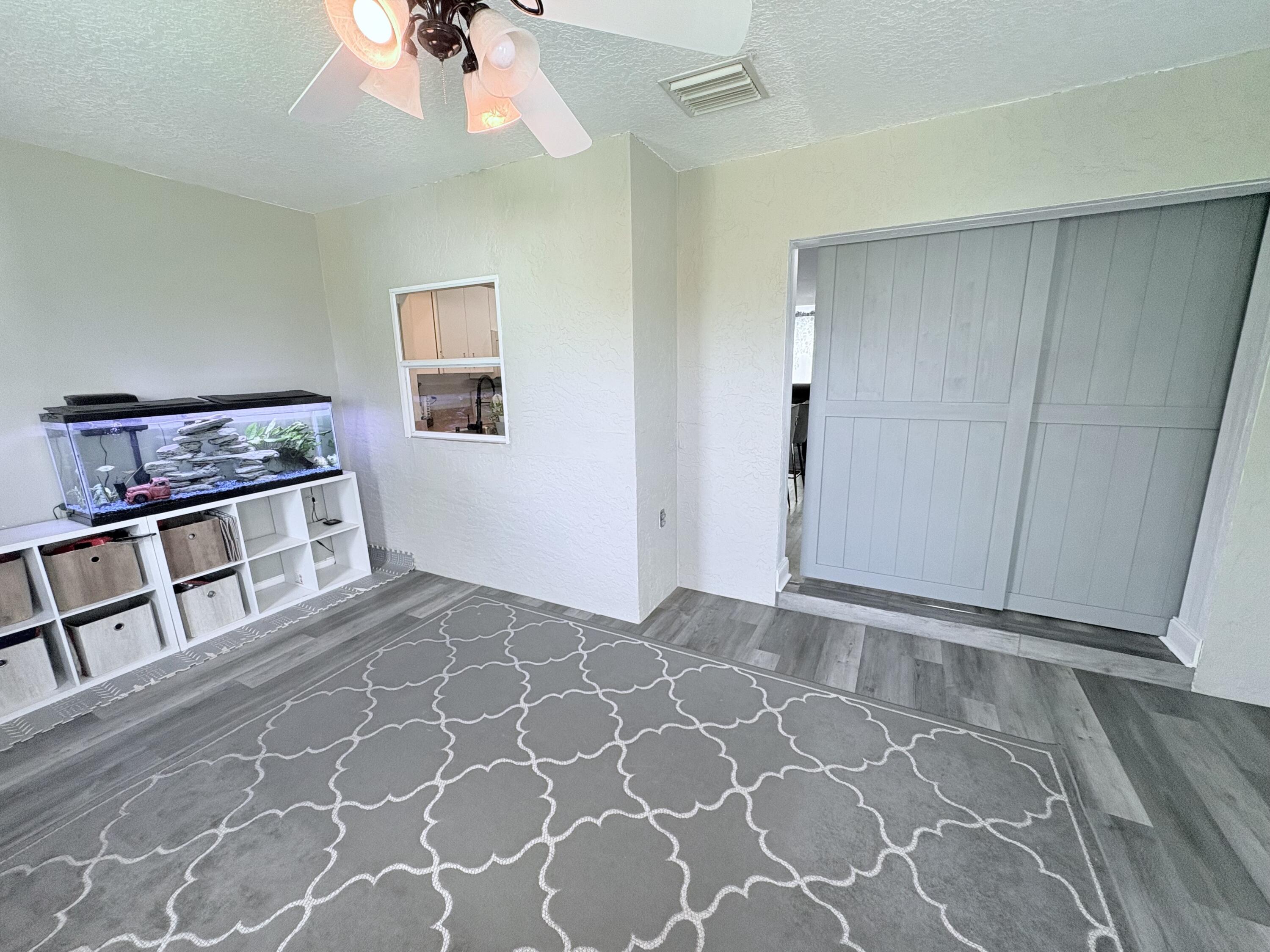 462 Southeast Cork Road Port St. Lucie, FL 34984 - Photo 25 of 57 a view of an empty room with a window