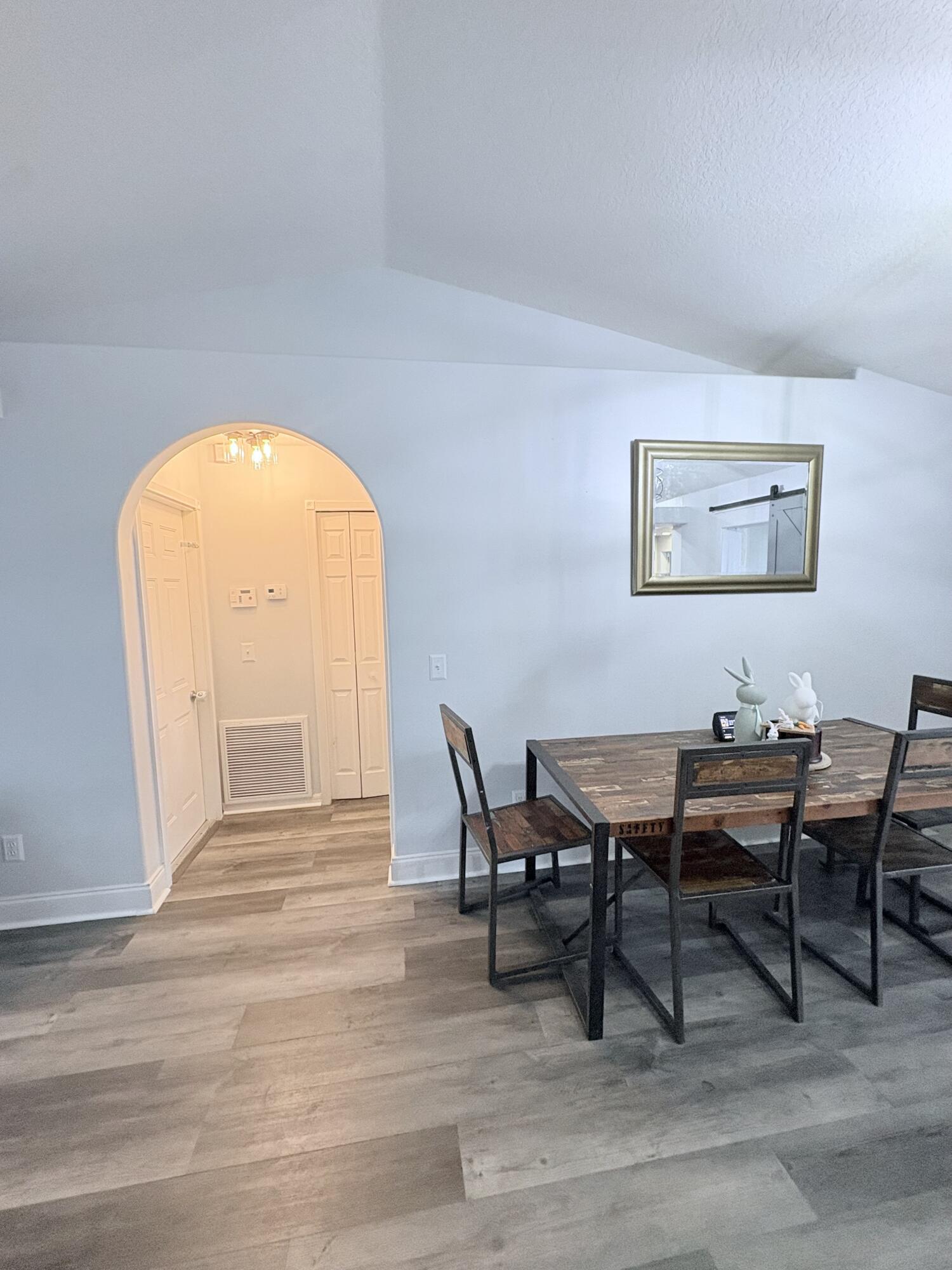 462 Southeast Cork Road Port St. Lucie, FL 34984 - Photo 28 of 57 a view of a dining room with furniture and wooden floor