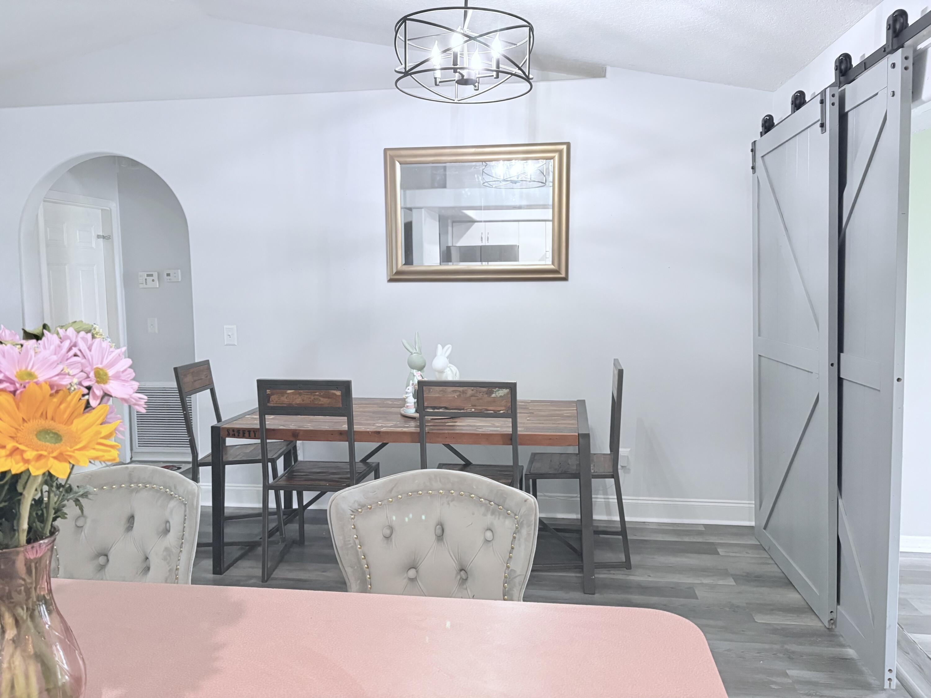 462 Southeast Cork Road Port St. Lucie, FL 34984 - Photo 29 of 57 a living room with furniture a table and chair