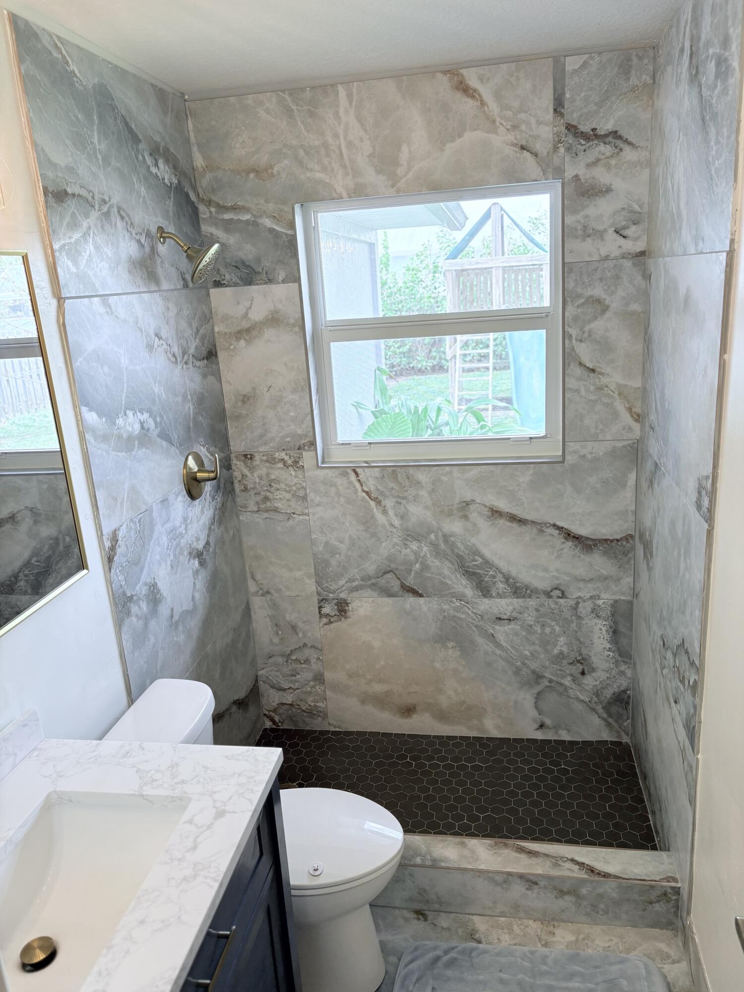 462 Southeast Cork Road Port St. Lucie, FL 34984 - Photo 41 of 57 a bathroom with a sink and a toilet