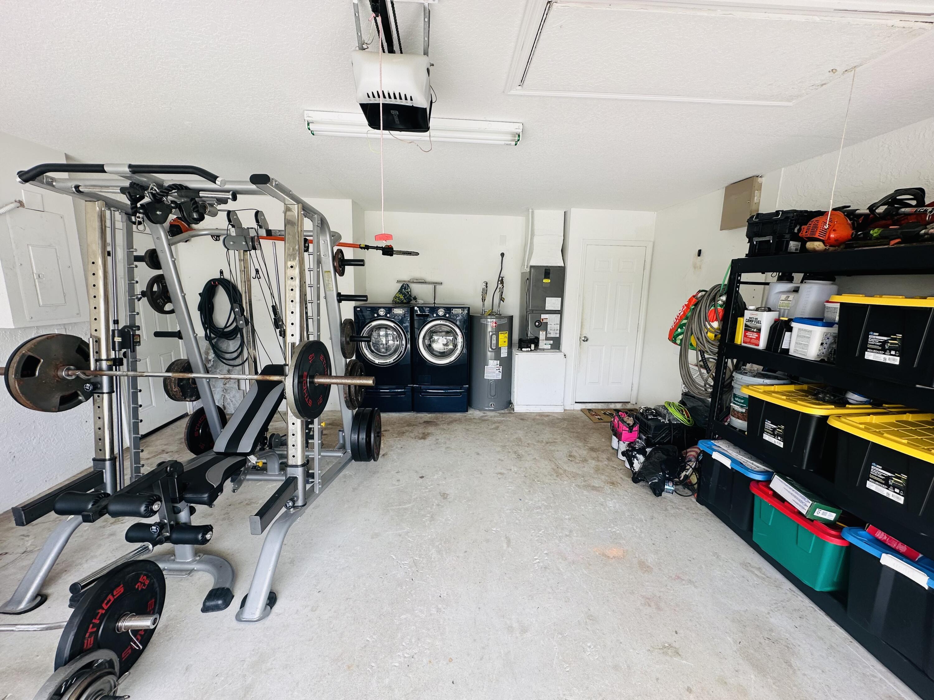 462 Southeast Cork Road Port St. Lucie, FL 34984 - Photo 45 of 57 a view of a garage with a bike and white