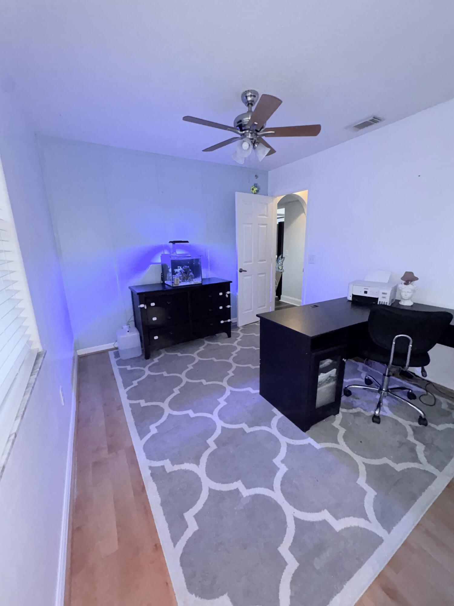 462 Southeast Cork Road Port St. Lucie, FL 34984 - Photo 53 of 57 a bed room with a bed and a chair