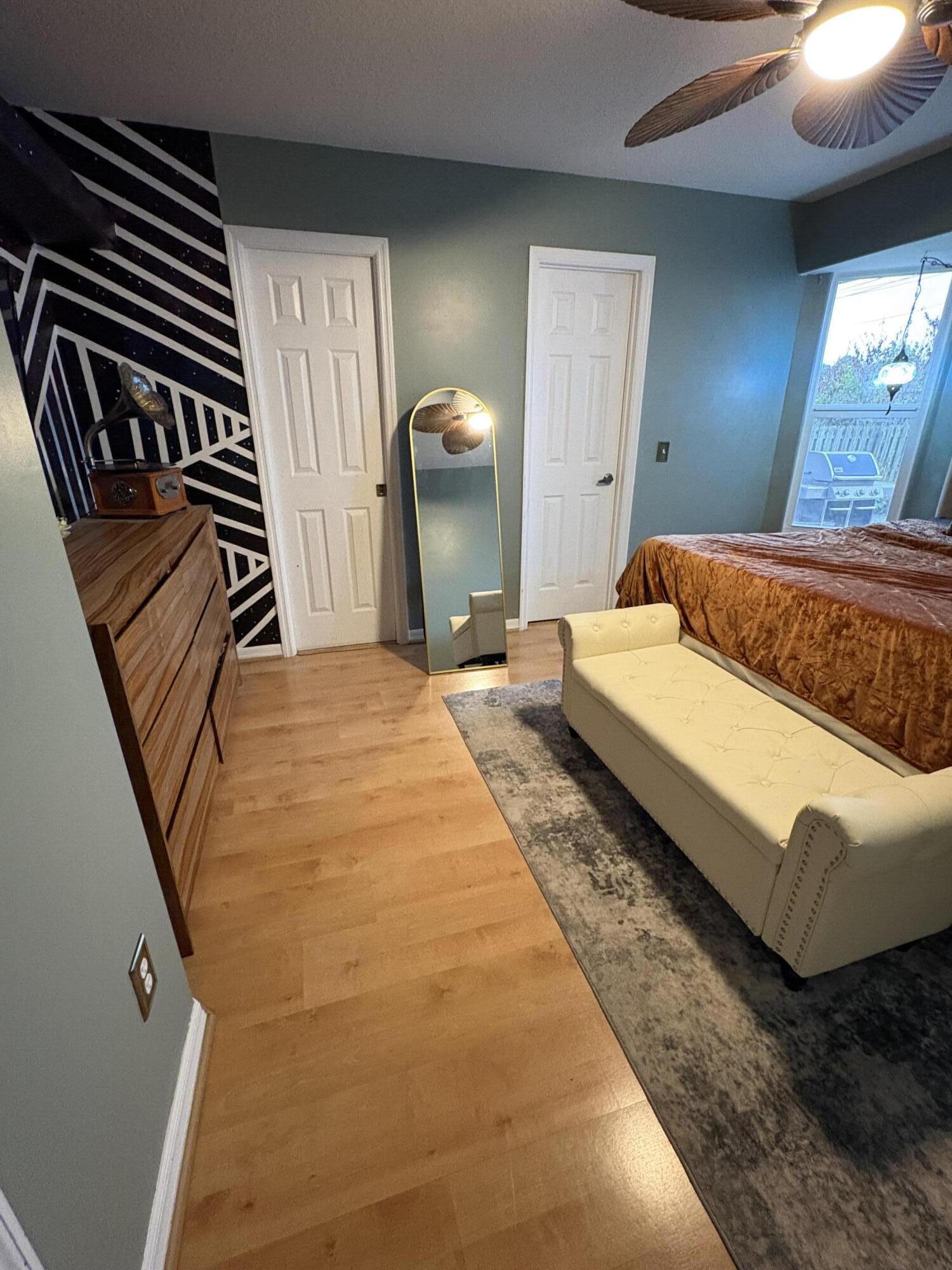 462 Southeast Cork Road Port St. Lucie, FL 34984 - Photo 54 of 57 a bedroom with a bed and a chandelier