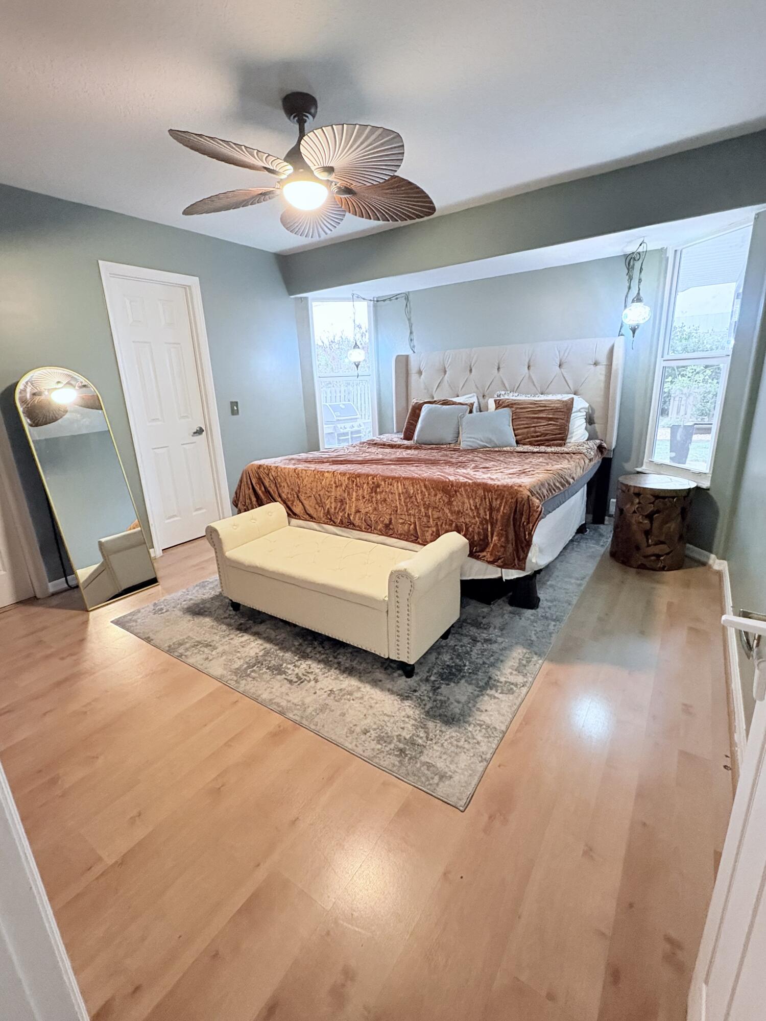 462 Southeast Cork Road Port St. Lucie, FL 34984 - Photo 57 of 57 a spacious bedroom with a bed and wooden floor
