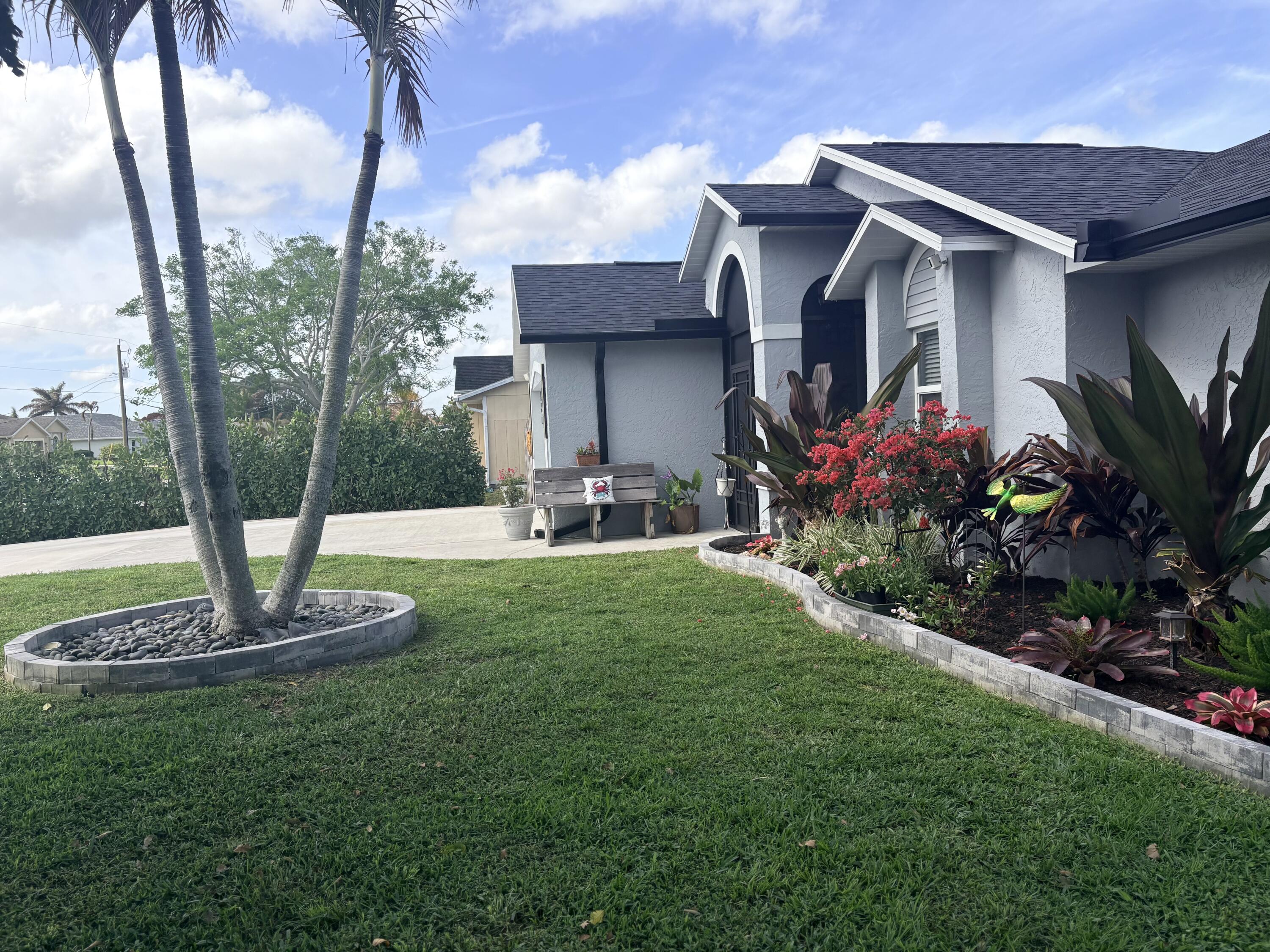 462 Southeast Cork Road Port St. Lucie, FL 34984 - Photo 6 of 57 a house view with a garden space