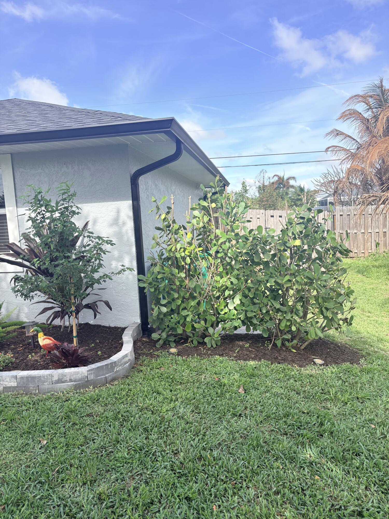 462 Southeast Cork Road Port St. Lucie, FL 34984 - Photo 9 of 57 a front view of a house with a yard