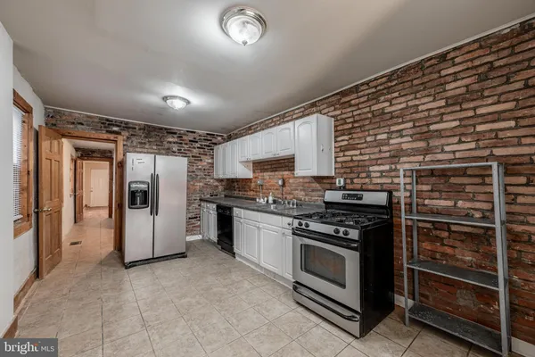 a kitchen with stainless steel appliances granite countertop a stove and a refrigerator