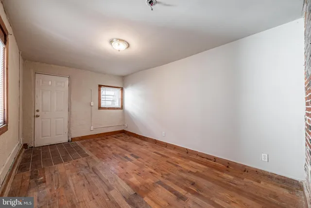 a view of wooden floor and windows in a room