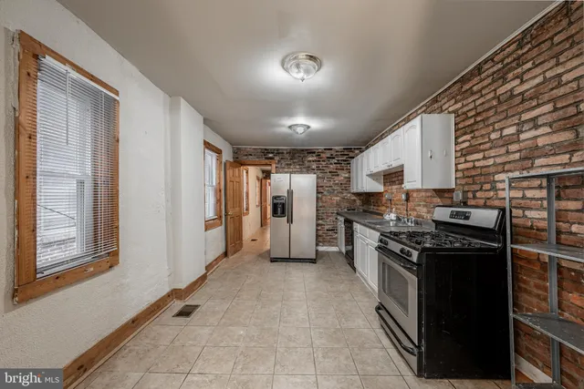 a kitchen with stainless steel appliances granite countertop a stove and a refrigerator