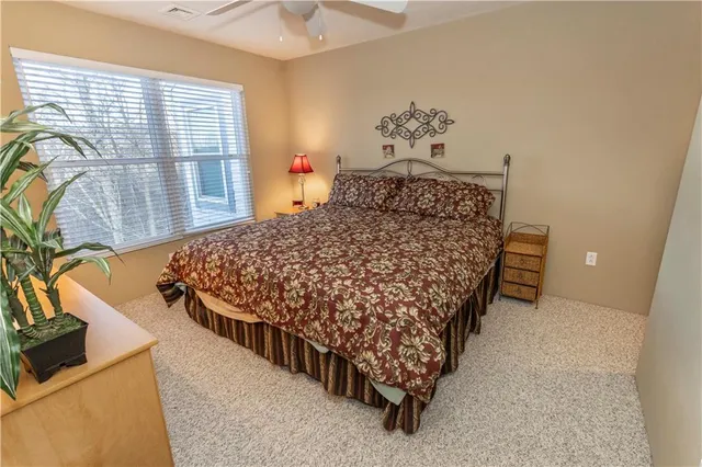 a bed sitting in a bedroom next to a window