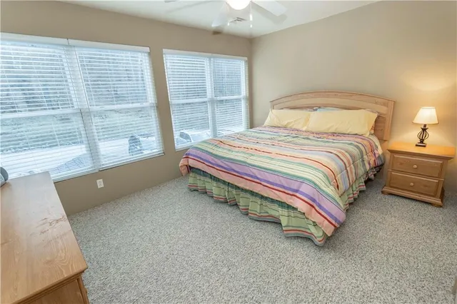 a spacious bedroom with a bed and a large window