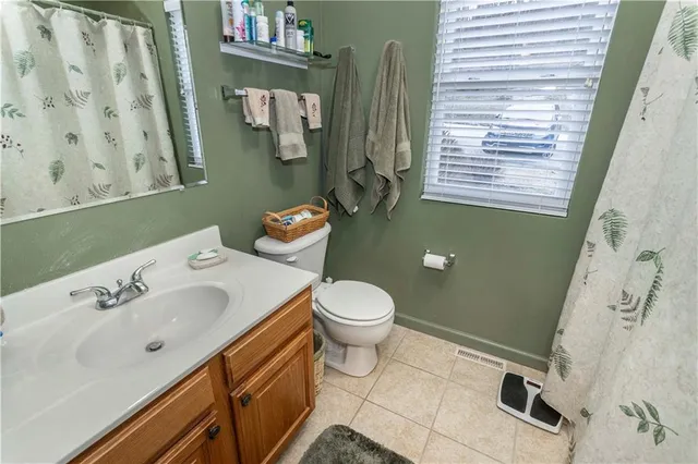 a bathroom with a sink a toilet and mirror