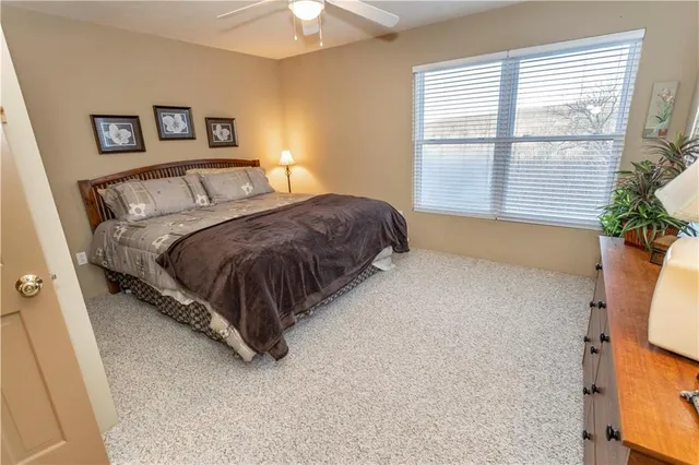 a bedroom with a bed and a potted plant