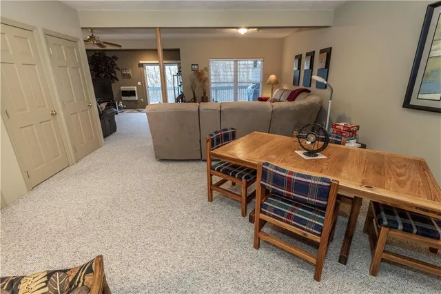 a living room with furniture a flat screen tv and a window