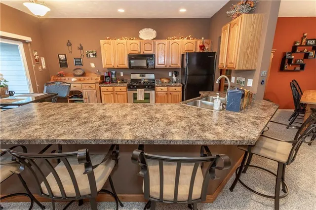 a large kitchen with a table and chairs