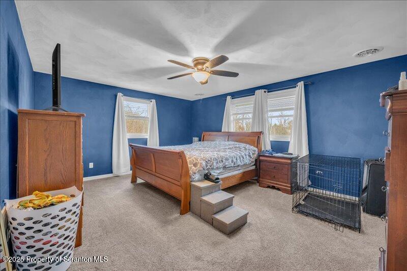 895 Cemetery Road Little Meadows, PA 18830 - Photo 21 of 40 a bedroom with a bed and a chandelier
