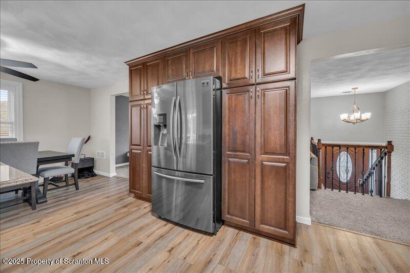 895 Cemetery Road Little Meadows, PA 18830 - Photo 25 of 40 a kitchen with wooden floor and a refrigerator