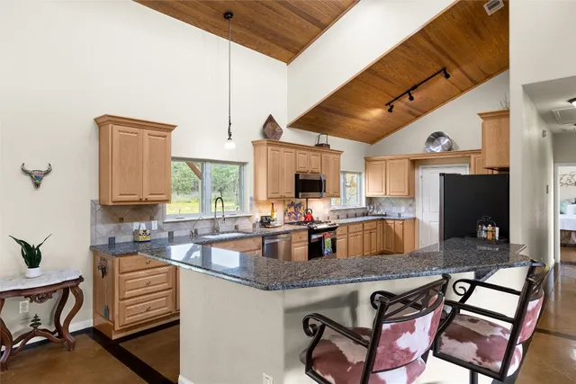 a kitchen with a stove and a refrigerator