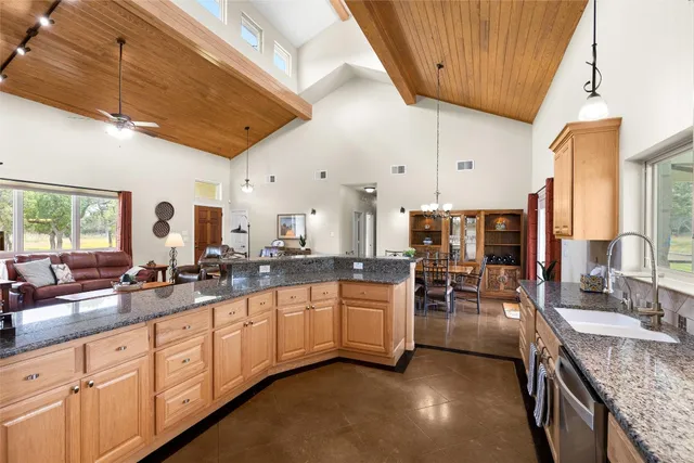 a large white kitchen with lots of counter space and a sink
