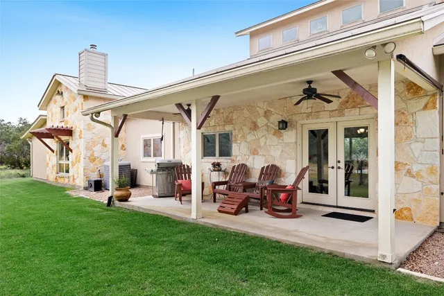a view of a house with backyard porch and sitting area