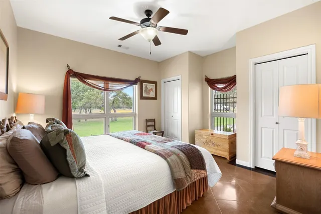 a bedroom with a bed and a large window