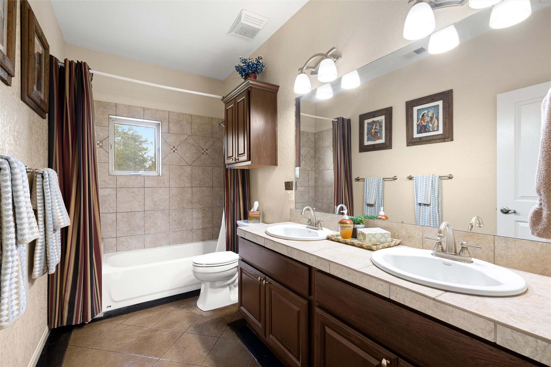 426 Preiss Ranch Road Blanco, TX 78606 - Photo 28 of 40 a bathroom with a double vanity sink a toilet a mirror and shower