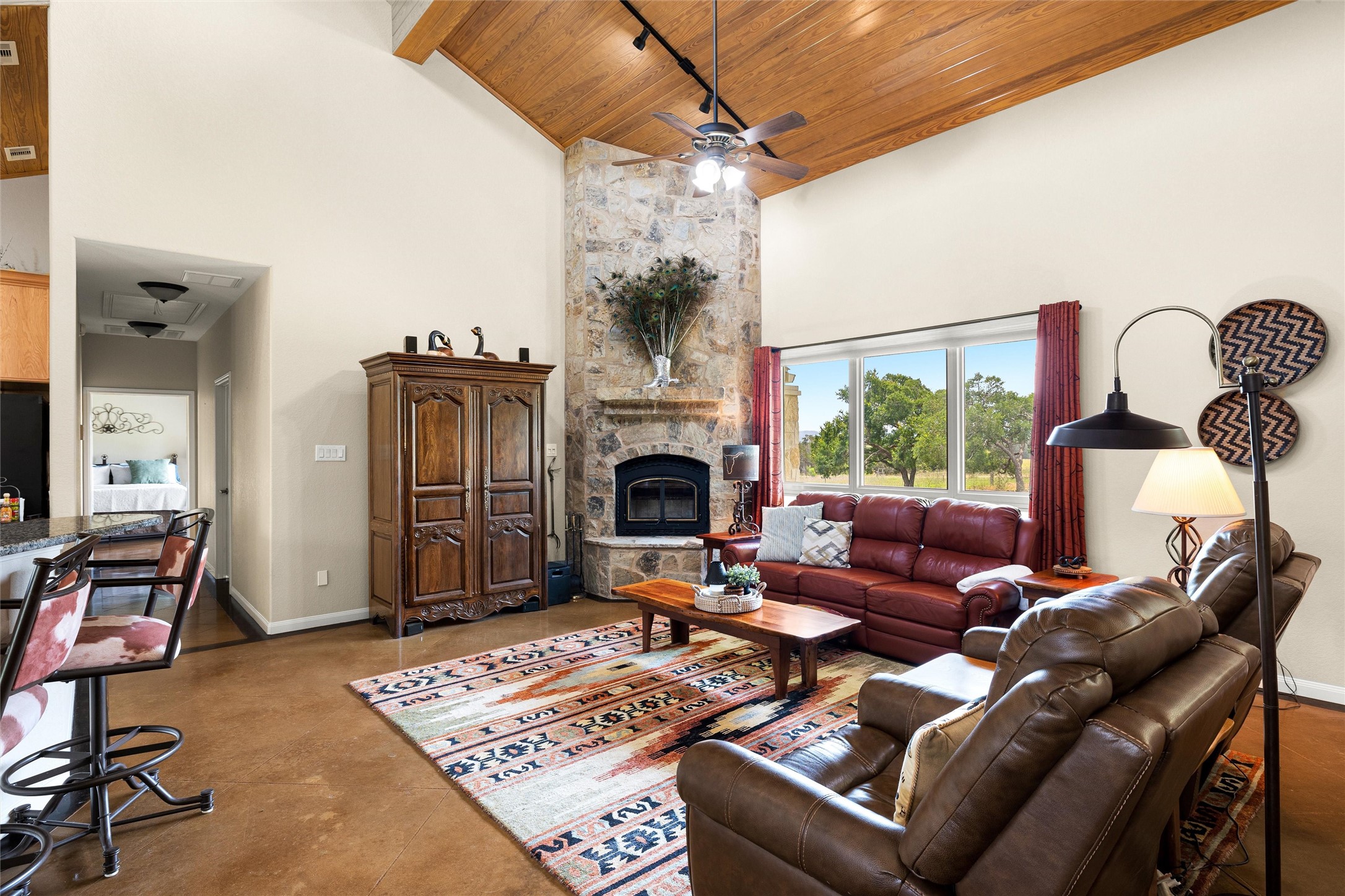 426 Preiss Ranch Road Blanco, TX 78606 - Photo 10 of 40 a living room with furniture a fireplace and a potted plant