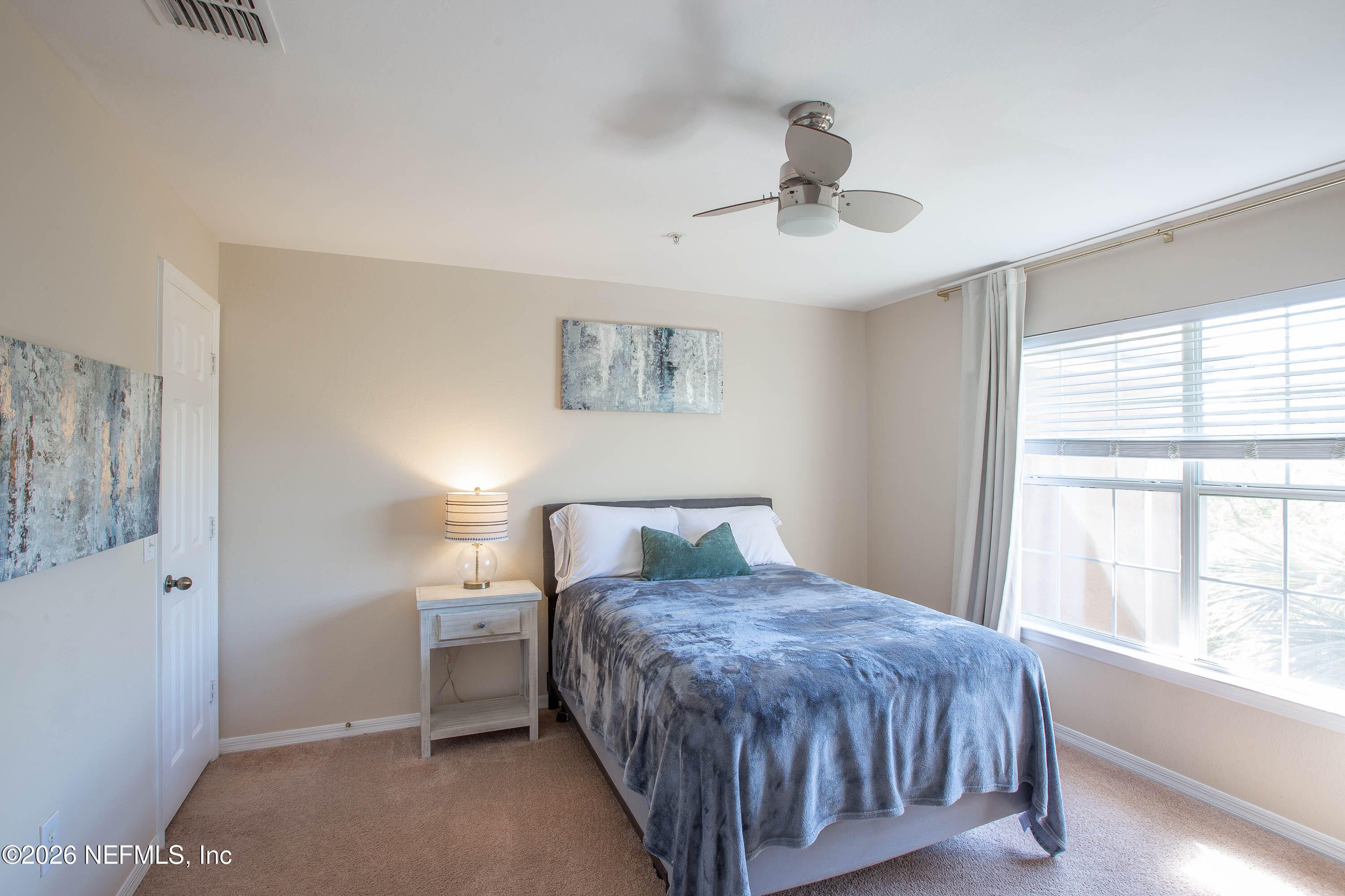 10961 Burnt Mill Road, Unit 734 Jacksonville, FL 32256 - Photo 11 of 35 a bedroom with a large bed and a window