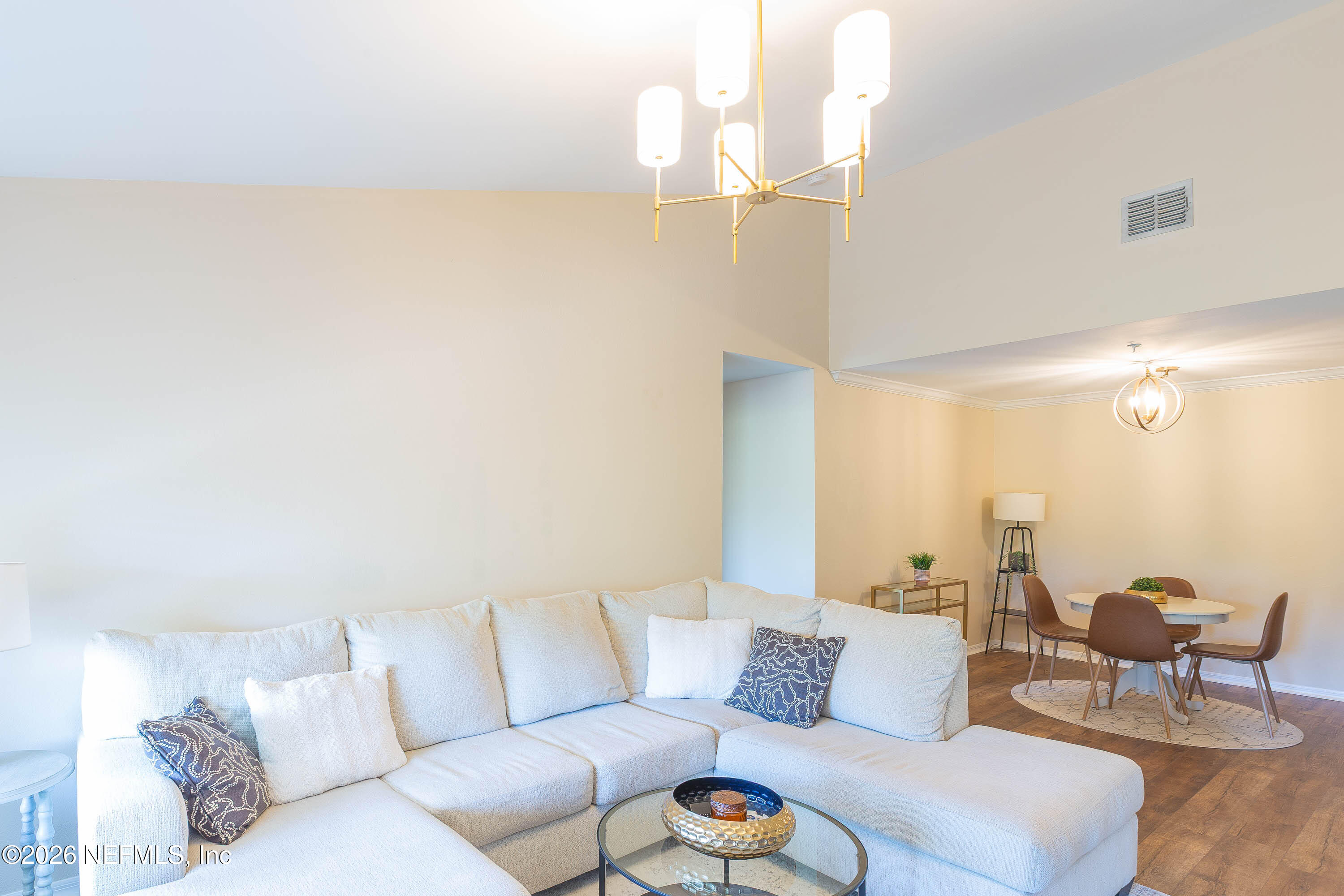 10961 Burnt Mill Road, Unit 734 Jacksonville, FL 32256 - Photo 13 of 35 a living room with furniture and a chandelier