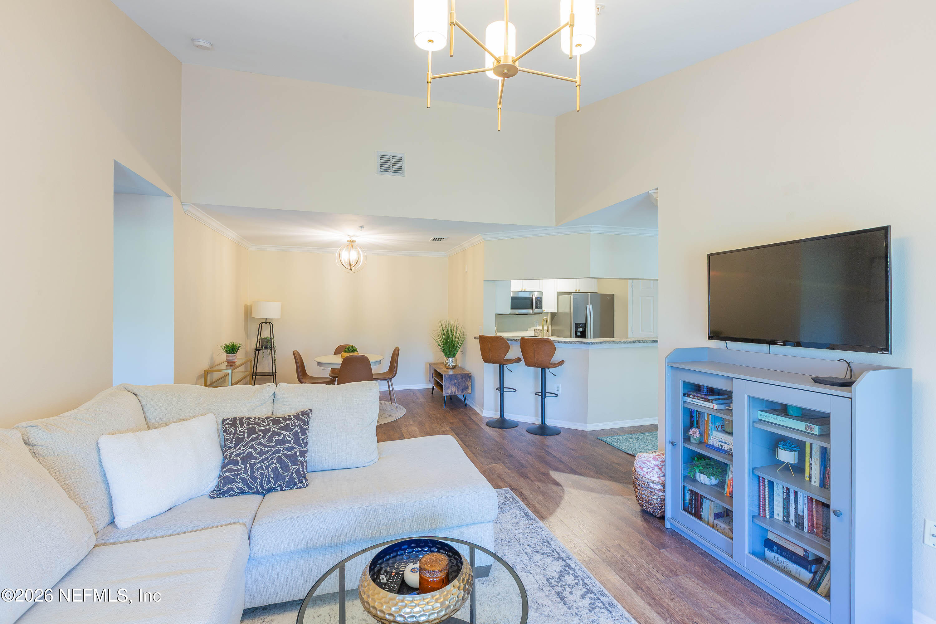 10961 Burnt Mill Road, Unit 734 Jacksonville, FL 32256 - Photo 14 of 35 a living room with furniture and a flat screen tv