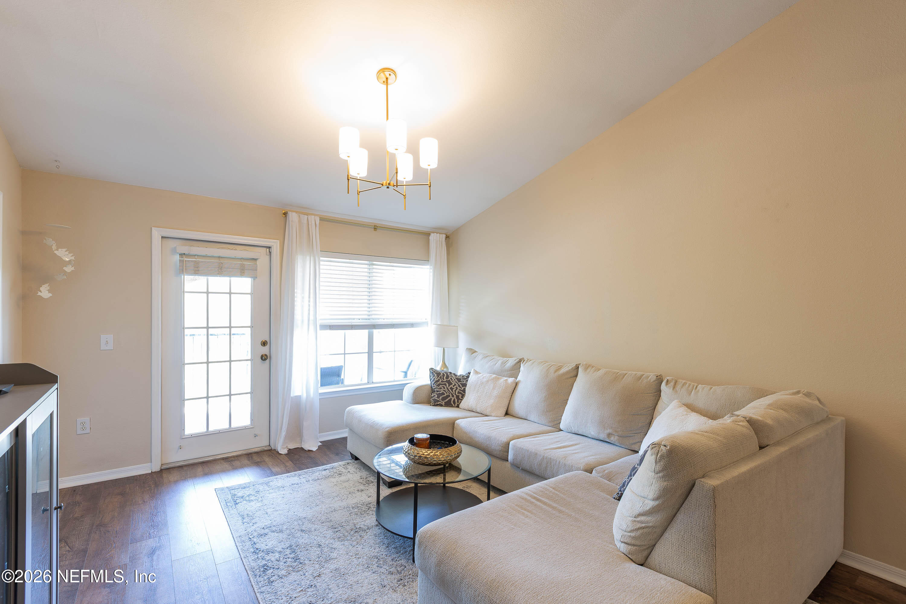10961 Burnt Mill Road, Unit 734 Jacksonville, FL 32256 - Photo 15 of 35 a living room with furniture and a chandelier