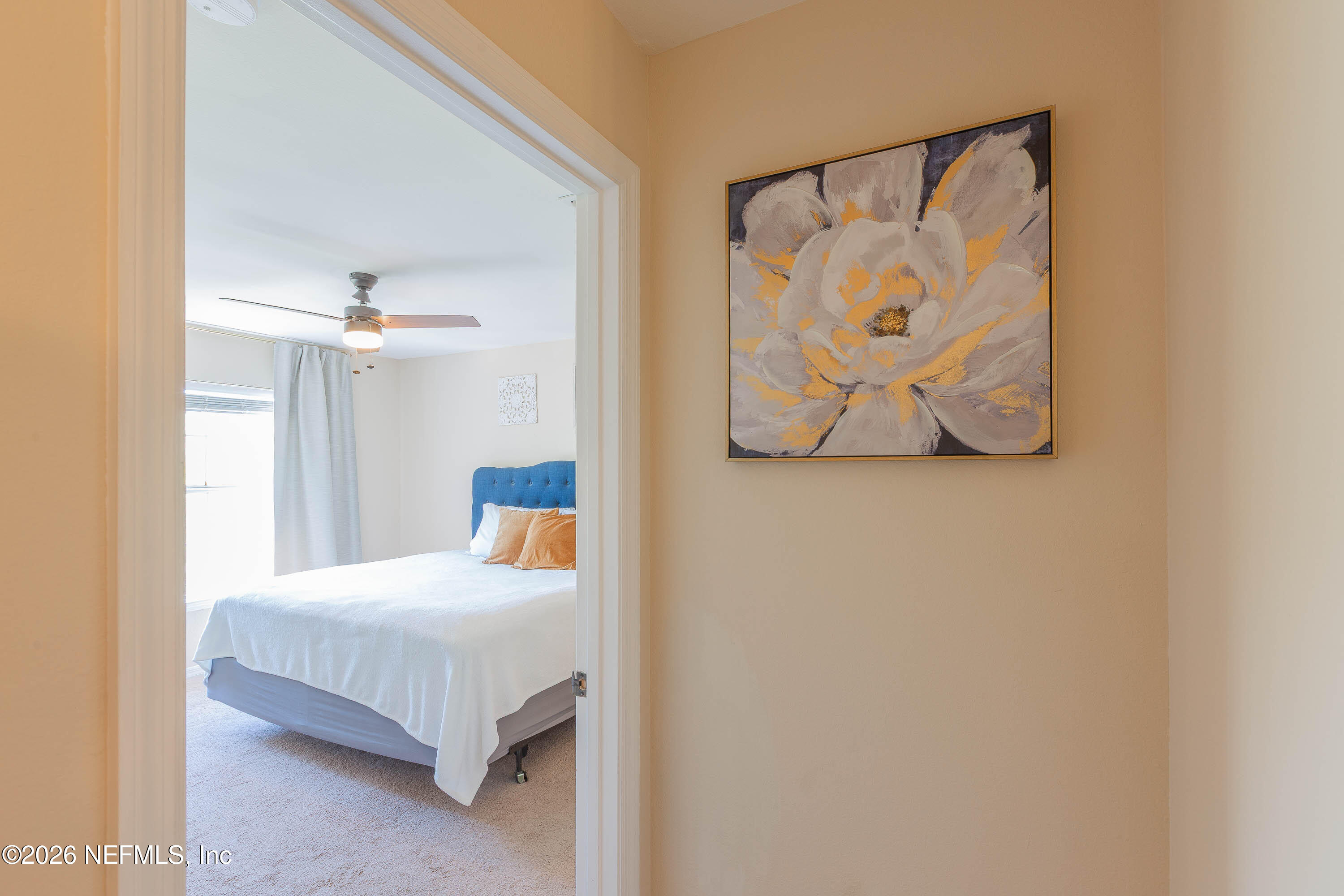 10961 Burnt Mill Road, Unit 734 Jacksonville, FL 32256 - Photo 17 of 35 a bedroom with a bed and painting on the wall